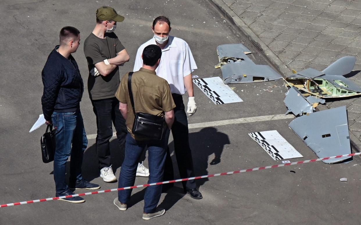 Emergency services inspect the wreckage of a drone that struck in a residential area of Moscow - Aleksandr Kazakov