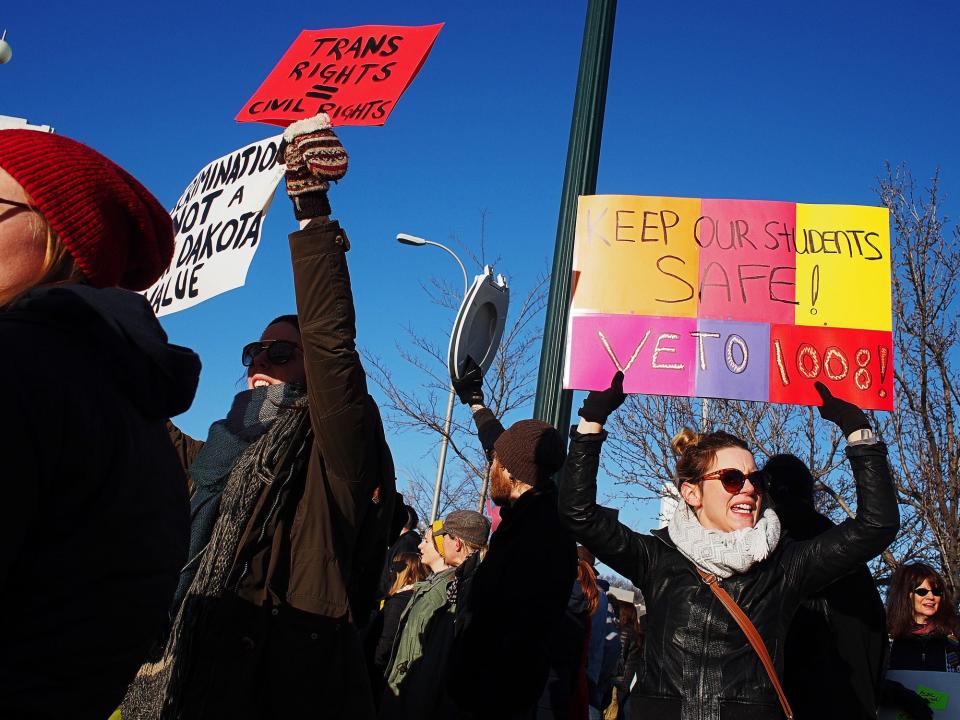 Protesters, including Alisha Grove, of Sioux Falls, take part in the Hold Them Accountable: Legislative Coffee Protest against HB 1008 on Saturday, Feb. 20, 2016, in front of the downtown Holiday Inn in Sioux Falls.