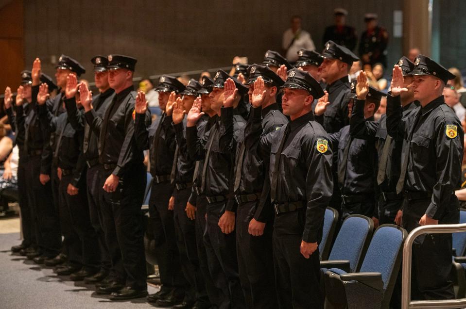 Recruits are sworn in during the Worcester Fire Department recruit class graduation ceremony.