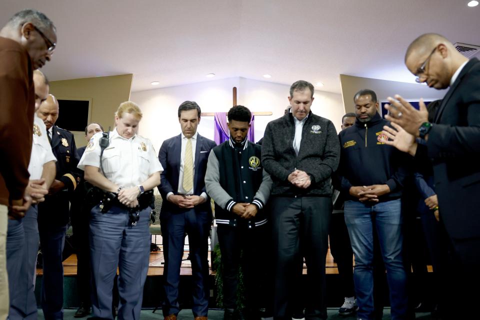 Baltimore Mayor Brandon Scott, center, is surrounded by city officials during a prayer at a vigil for victims of the Francis Scott Key Bridge collapse at the Mount Olive Baptist Church on March 26, 2024 in Baltimore, Maryland.