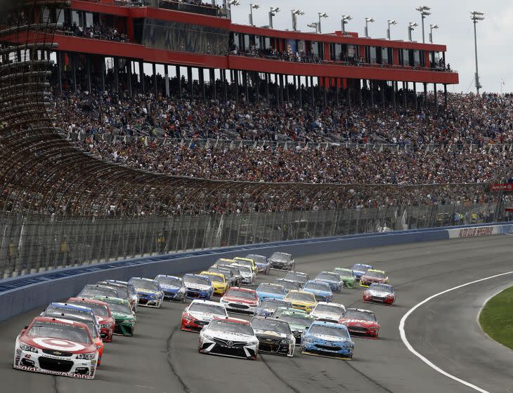 Kyle Larson, front left, takes the lead from the pole position at the start of the NASCAR Cup Series.