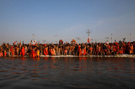 Naga Sadhus or Hindu holy men prepare to take a dip during the first "Shahi Snan" (grand bath) during "Kumbh Mela" or the Pitcher Festival, in Prayagraj, previously known as Allahabad, India, January 15, 2019. Picture taken January 15, 2019. REUTERS/Danish Siddiqui