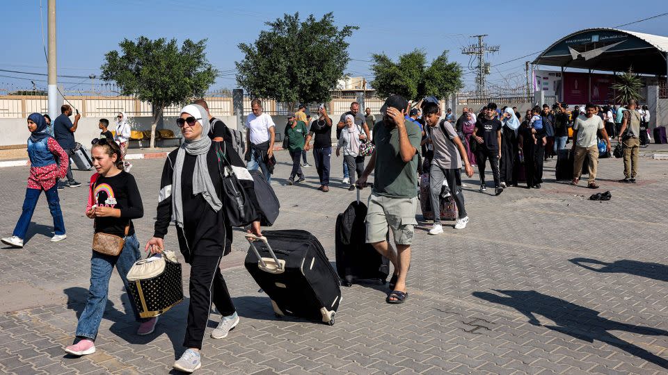 People enter the Rafah border crossing in the southern Gaza Strip in preparation for crossing into Egypt on November 1, 2023. - Mohammed Abed/AFP/Getty Images