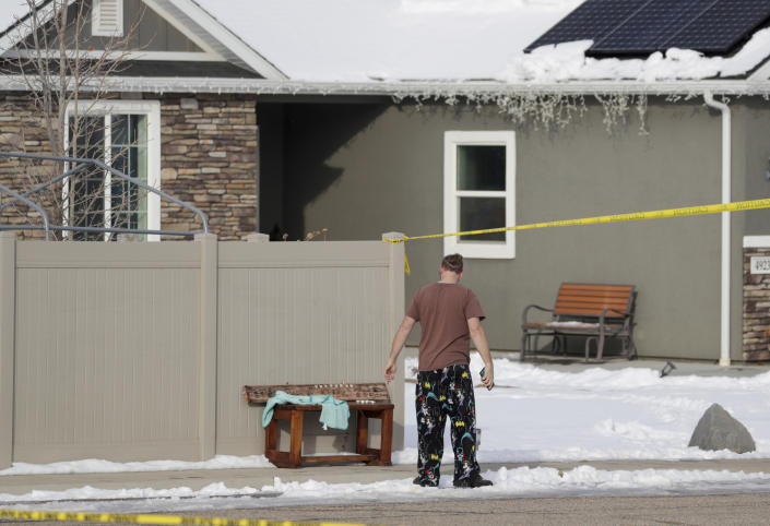 A neighbor puts a bench in front of the house where eight members of a family were killed in Enoch, Iron County, on Thursday, Jan. 5, 2023. Officials said Michael Haight, 42, took his own life after killing his wife, mother-in-law and the couple's five children. (Ben B. Braun/The Deseret News via AP)