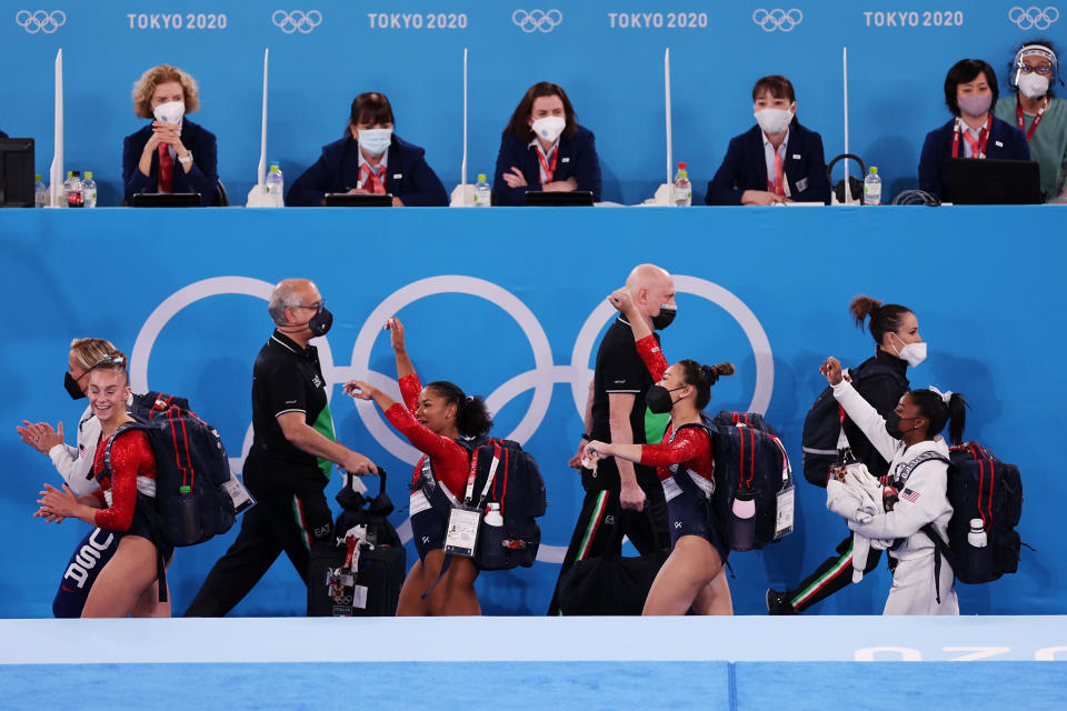 Team United States walks past the judges on day four of the Tokyo 2020 Olympic Games. Some Olympic sports, like track, are not subjective. The fastest is the fastest. But for more subjective sports like gymnastics, multiple judges are chosen to sit on panels and rules are built in to try and ensure impartiality.  / Credit: / Getty Images