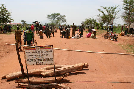 South Sudanese refugees gather their belongings as they enter Uganda at the Ngomoromo border post in Lamwo district, northern Uganda, April 4, 2017. REUTERS/Stringer