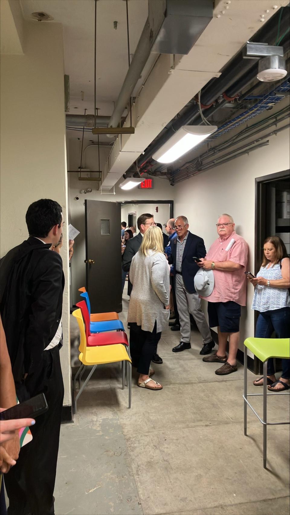 Members of the Des Moines City Council and meeting attendees take shelter in the basement of city hall after a tornado warning was issued for Des Moines on Monday, July 15, 2024.
