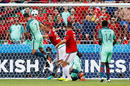 Football Soccer - Hungary v Portugal - EURO 2016 - Group F - Stade de Lyon, Lyon, France - 22/6/16 Portugal's Cristiano Ronaldo scores their third goal REUTERS/Jason Cairnduff