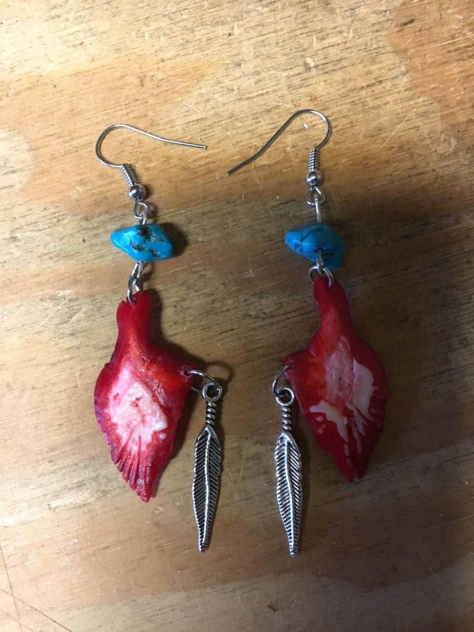 Earrings created by Douglas P. Fazzio using the ganoid scales of gar fish and dyed with Kool Aid.