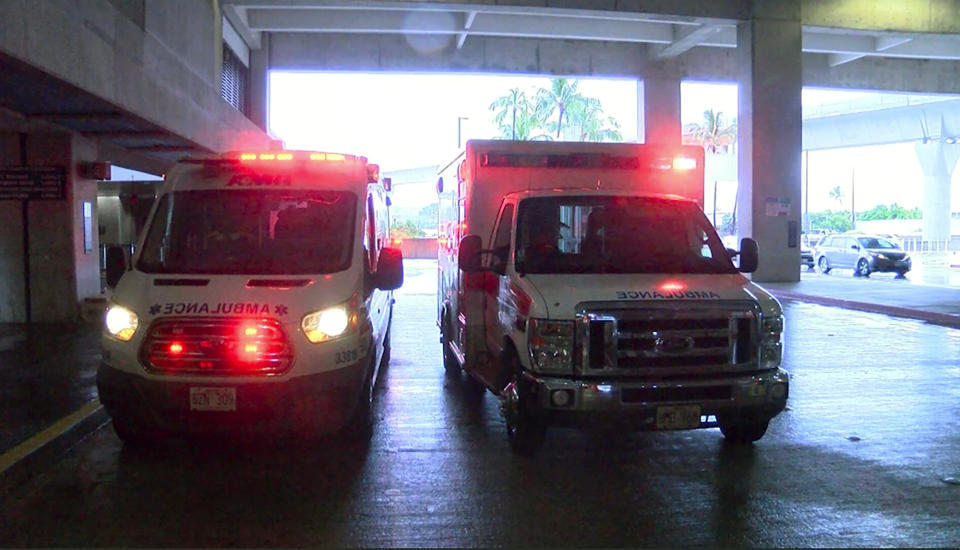In this image taken from a video provided by Hawaii News Now ambulances remain outside the international airport in Honolulu after multiple people were seriously injured when a flight to Hawaii hit severe turbulence on Sunday, Dec. 18, 2022. (Hawaii News Now via AP)