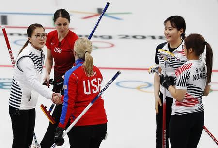 Curling - Pyeongchang 2018 Winter Olympics - Women's Round Robin - U.S. v South Korea - Gangneung Curling Center - Gangneung, South Korea - February 20, 2018 - Skip Kim Eun-jung of South Korea shakes hands with skip Nina Roth of the U.S. next to Tabitha Peterson of the U.S. and Kim Seon-yeong Kim Cho-hi of South Korea. REUTERS/Cathal McNaughton