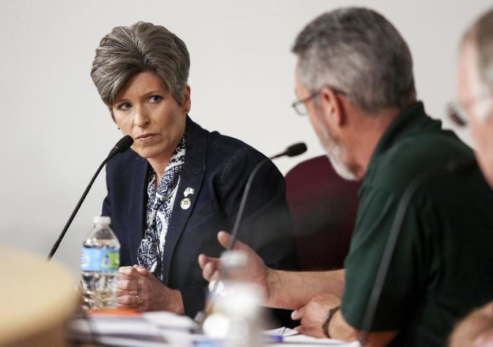 Sen. Joni Ernst, R-Iowa, left, listens to concerns during a veterans roundtable event at Maquoketa City Hall on Tuesday, Feb. 21, 2017, in Maquoketa, Iowa. Iowa’s U.S. senators were met Tuesday with overflow crowds who pointedly questioned them about President Donald Trump’s actions during his first month in office and other issues. Although Republican Sens. Charles Grassley and Ernst held meetings in small towns in northern and eastern Iowa, they drew big crowds. (Nicki Kohl/Telegraph Herald via AP)