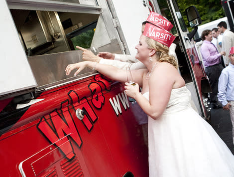 Bride getting food from a food truck.