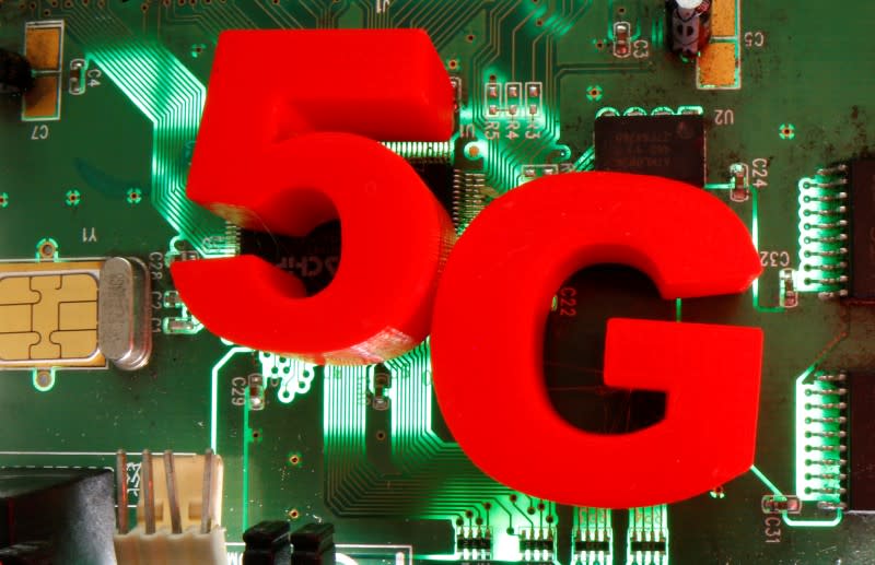 3d printed objects representing 5G are put on a motherboard in this picture illustration