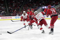 Carolina Hurricanes defenseman Brady Skjei (76) hits Detroit Red Wings center Dylan Larkin, second from right, during the first period of an NHL hockey game Thursday, April 14, 2022, in Raleigh, N.C. (AP Photo/Chris Seward)