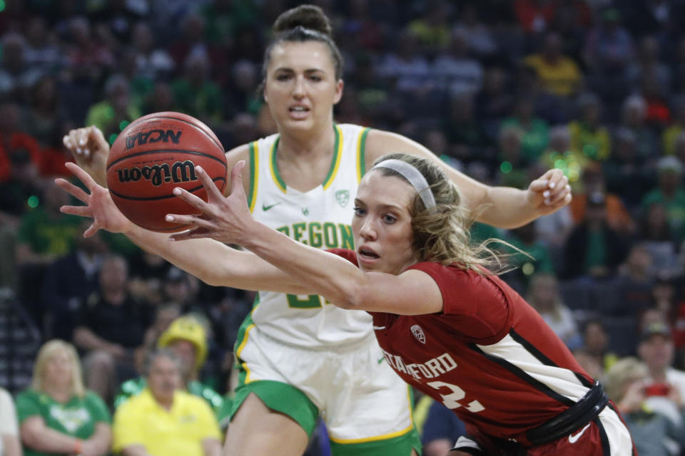 FILE - In this March 8, 2020, file photo, Stanford's Lexie Hull (12), right, grabs the ball around Oregon's Erin Boley, left, during the first half of an NCAA college basketball game in the final of the Pac-12 women's tournament in Las Vegas. Stanford is ranked No. 2 in the women's NCAA college basketball poll released Tuesday, Nov. 10, 2020. (AP Photo/John Locher, File)