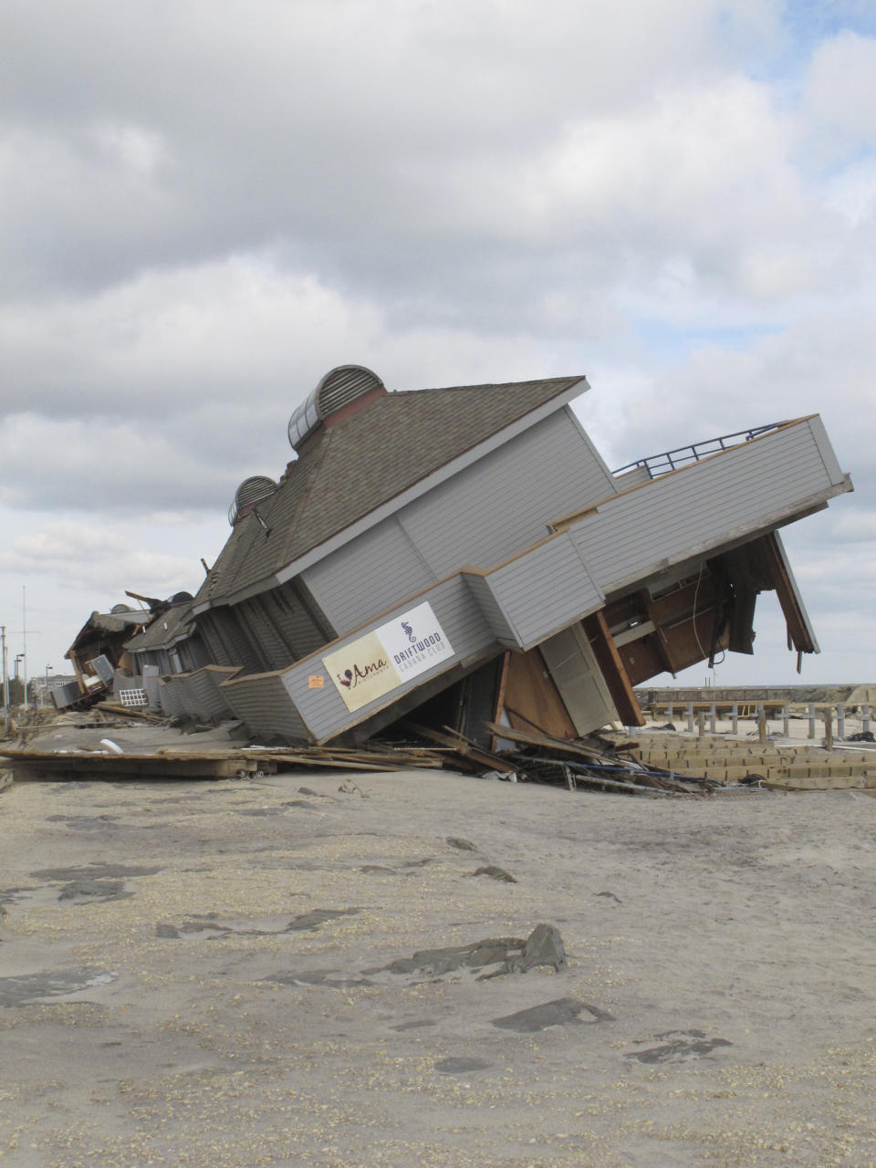 A beach club destroyed by Superstorm Sandy on the sea wall on Nov. 15, 2022, in Sea Bright, N.J. New Jersey, like places around the world, is setting ambitious goals to deal with climate change, but it wrestling with how much to actually require of businesses and individuals to fulfill those goals. (AP Photo/Wayne Parry)