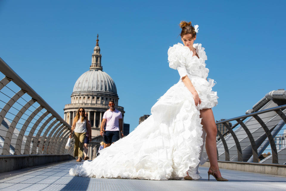 <p>EDITORIAL USE ONLY Jemima Hambro models, on the Millennium Bridge in London, a wedding dress designed by Tom Silverwood and made from over 1,500 unwanted face masks, for wedding planning website, Hitched, to celebrate all restrictions on weddings lifting in England from Monday. Issue date: Monday July 19, 2021.</p>
