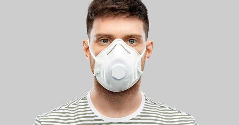 man wearing a face mask with a valve