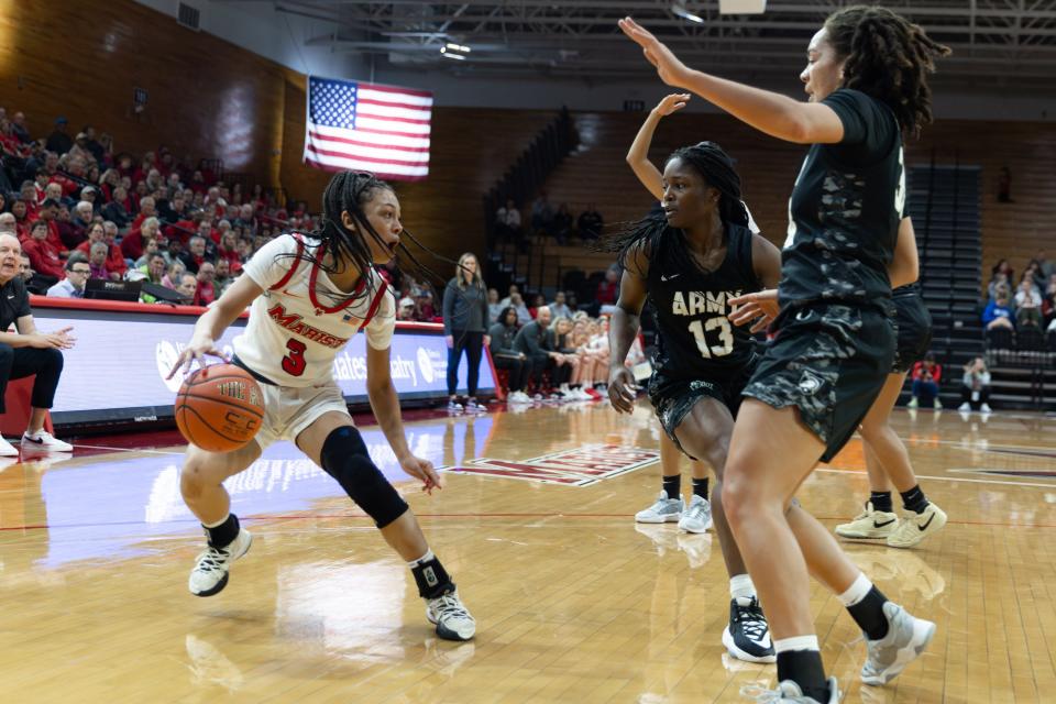 Marist's Kiara Fisher draws two defenders against Army during a Nov. 9, 2023 women's basketball game.