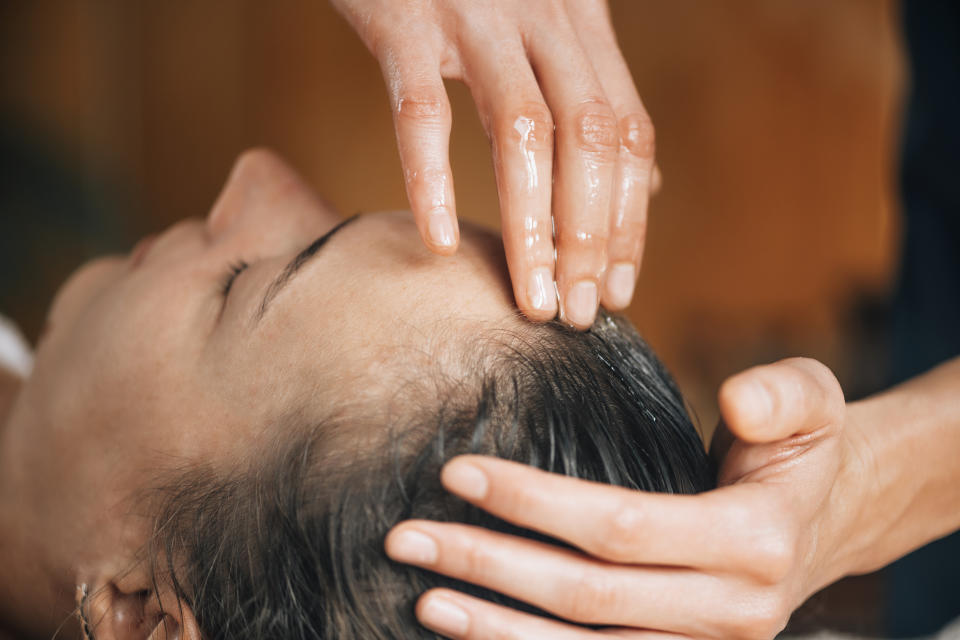 Woman enjoying Ayurvedic oil treatment for healthy hair