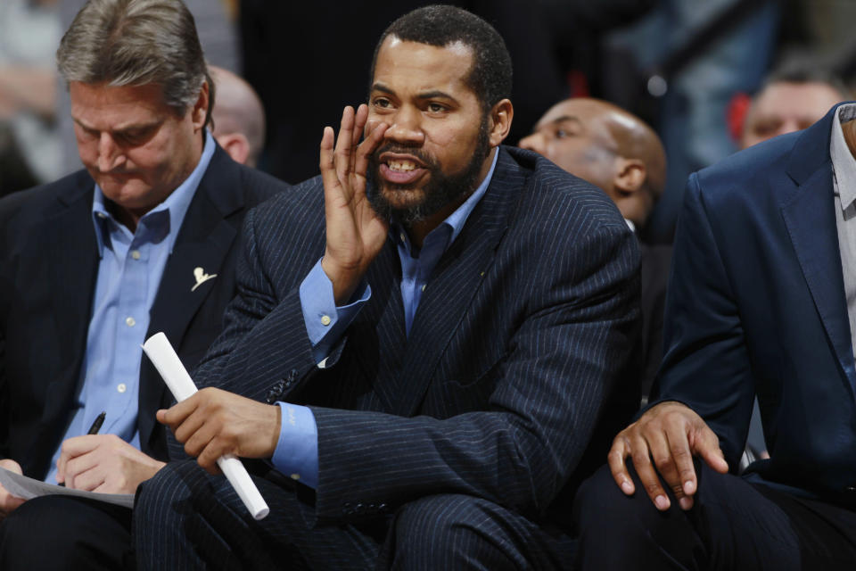 Detroit Pistons assistant coach Rasheed Wallace directs players against the Denver Nuggets in the third quarter of the Nuggets' 118-109 victory in an NBA basketball game in Denver on Wednesday, March 19, 2014. (AP Photo/David Zalubowski)