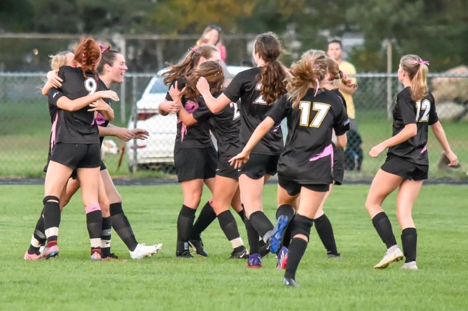 The Milton Yellowjackets celebrate the opening goal during their 6-5 overtime loss to the Rice Green Knights on Tuesday evening in Milton.