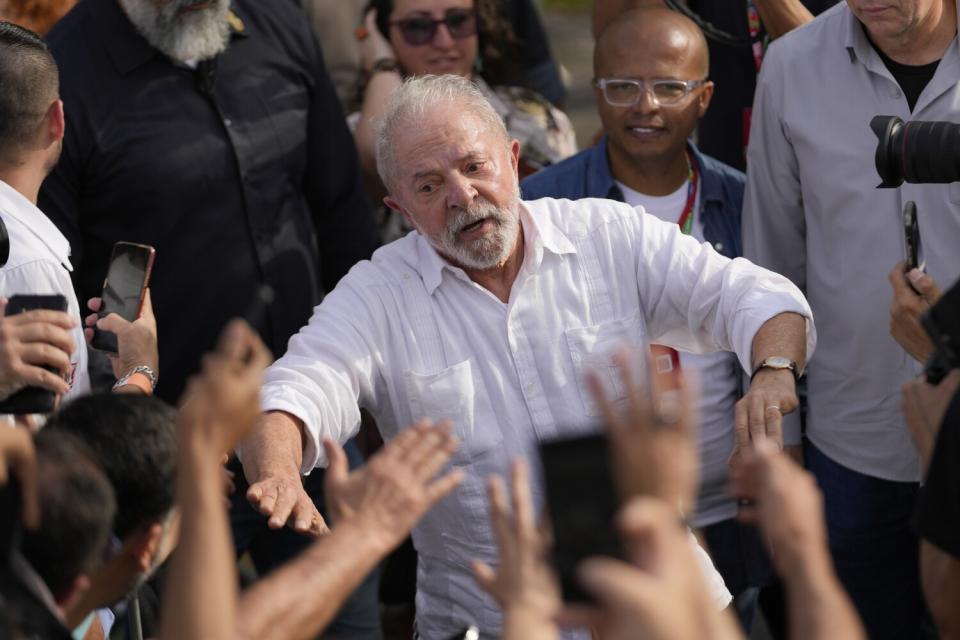 Former Brazilian President Luiz Inacio Lula da Silva greeting supporters