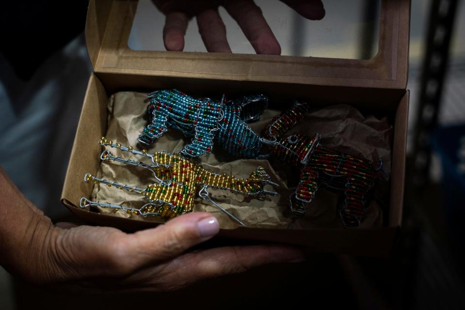 Becky Riess, of Sylvan Lake, co-owner of Thumbprint Artifacts, holds a gift box of beaded ornaments created by artisans in South Africa at the company's warehouse in Detroit on Wednesday, Nov. 2, 2022.