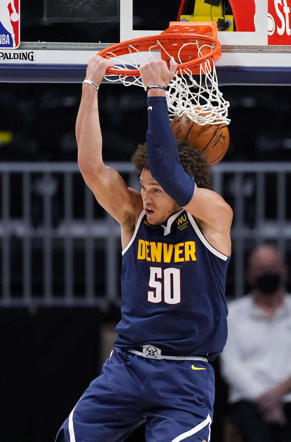 Denver Nuggets forward Aaron Gordon dunks the ball for a basket against the Boston Celtics in the first half of an NBA basketball game Sunday, April 11, 2021, in Denver. (AP Photo/David Zalubowski)