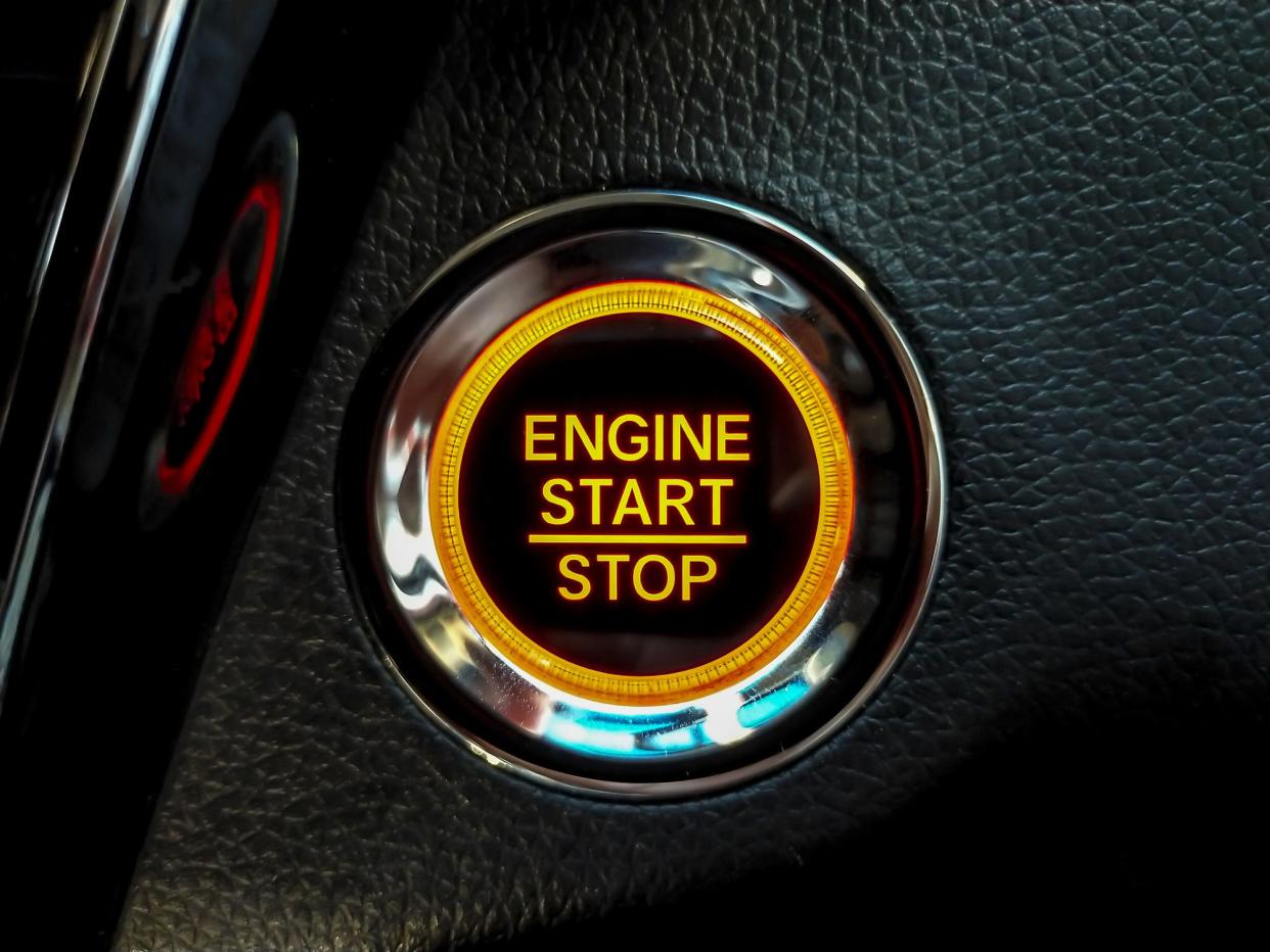 Engine Start or stop button in a conventional modern car. Car instrument panel, interior dashboard control.