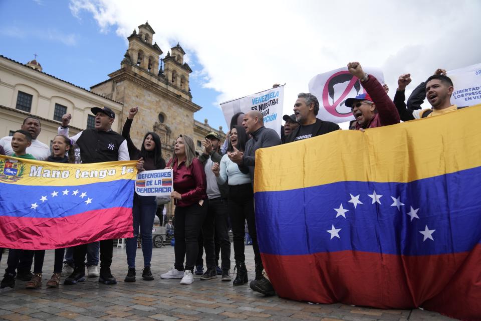 FILE - Venezuelans, who support opposition leader María Corina Machado, sing their native country's national anthem during a protest demanding free and fair elections in Venezuela's upcoming election, in Bolivar Square in Bogota, Colombia, April 6, 2024. Of the millions of Venezuelans who have fanned out around the world, including those who migrated before the economic crisis, only about 107,000 are registered to vote outside the South American country. (AP Photo/Fernando Vergara, File)