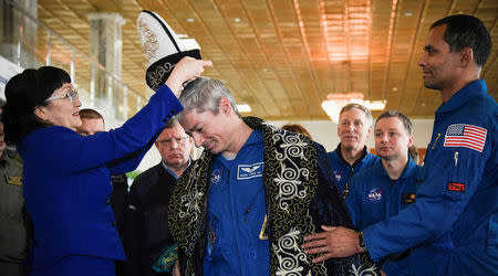 International Space Station crew member Mark Vande Hei of the U.S. receives a traditional Kazakh hat after a news conference in the town of Dzhezkazgan (Zhezkazgan), Kazakhstan, on February 28, 2018. REUTERS/Alexander Nemenov/Pool