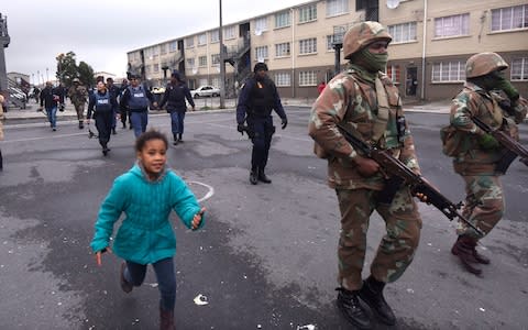 Soldiers patrol in Hanover Park, a notoriously violent township, on Thursday July 18 - Credit: The Telegraph/Brenton Geach