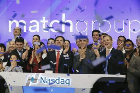 Greg Blatt (C), chairman of Match Group, and Sam Yagan (6th R), CEO of Match Group and co-founder and CEO of OkCupid, celebrate the Match Group's IPO at the NASDAQ stock exchange, New York November 20, 2015. REUTERS/Lucas Jackson