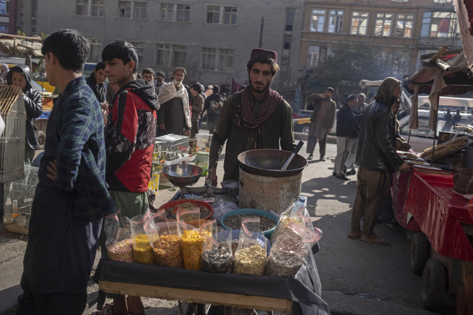 A street vendor pushes his cart in a market in Kabul, Afghanistan, Tuesday, Nov. 16, 2021. (AP Photo/Petros Giannakouris)