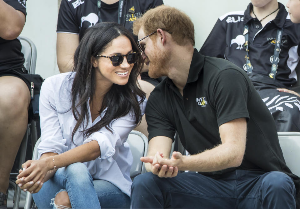 <p>Meghan and Harry made their first public appearance together at the Invictus Games Toronto in 2017. The pair giggled, held hands and whispered in each other’s ears, as they watched the action (PA) </p>