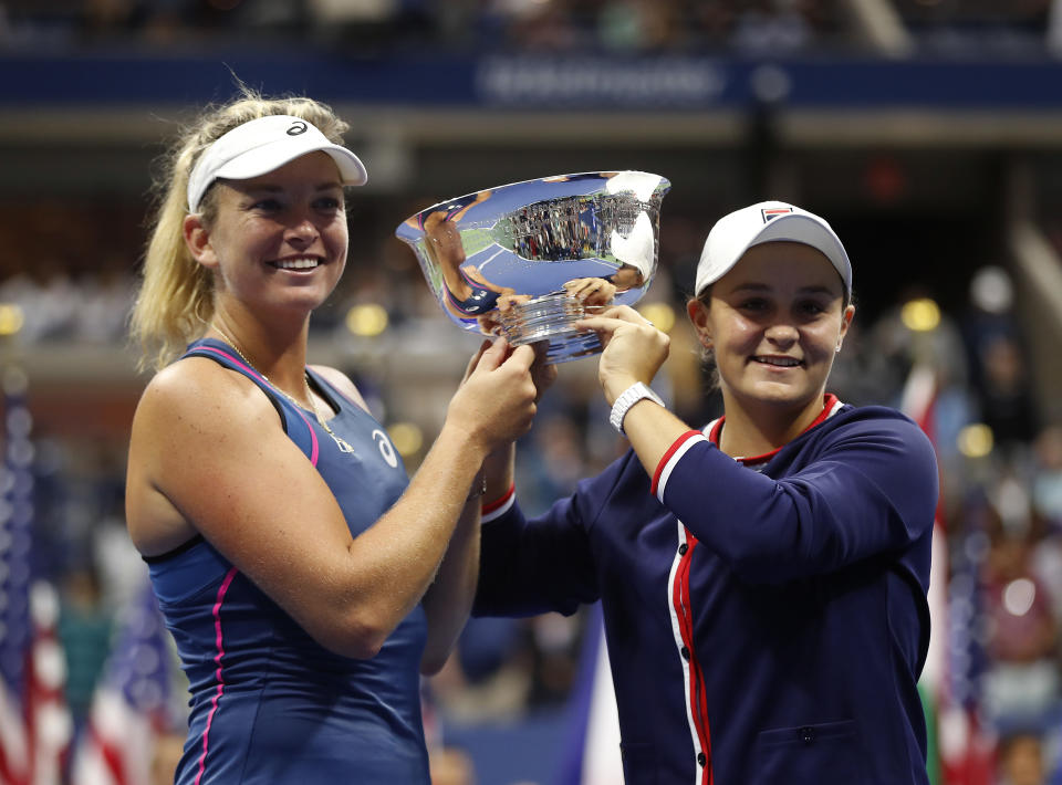 CoCo Vandeweghe, left, and Ashleigh Barty, of Australia, hold the trophy after defeating Timea Babos, of Hungary, and Kristina Mladenovic, of France, in the women's double final of the U.S. Open tennis tournament, Sunday, Sept. 9, 2018, in New York. (AP Photo/Adam Hunger)