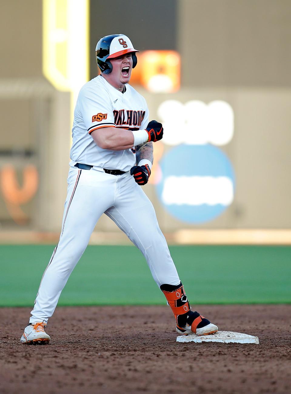 Oklahoma State's Griffin Doersching (52) celebrates a double in the fourth inning during the NCAA Stillwater Regional baseball game between Oklahoma State Cowboys and Missouri State Bears at the O'Brate Stadium in Stillwater, Okla., Friday, June, 3, 2022. 