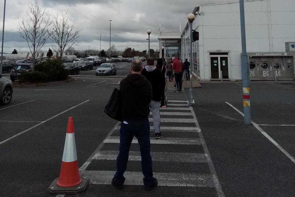 Customers social distancing in the queue to enter a Tesco store in New Ross, Co Wexford (PA)