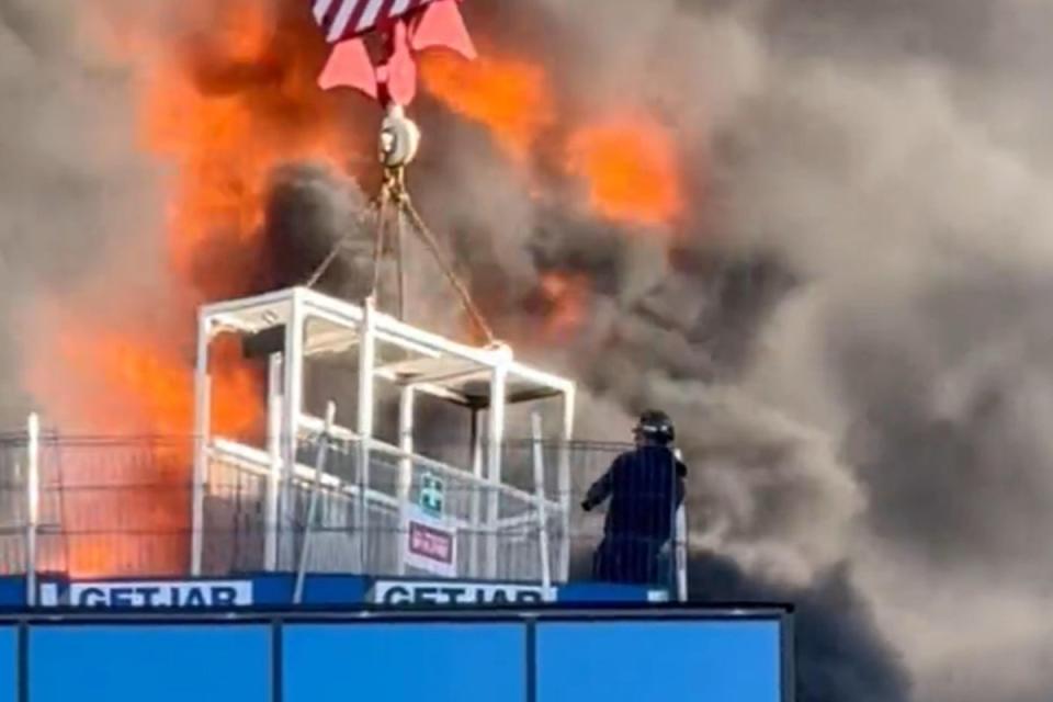 A workman was lifted to safety by a crane after a fire at a high-rise building in Reading (PA Media)