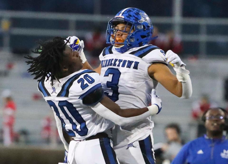 Middletown's Joshua Roberson (20) celebrates his second quarter touchdown run with Michael Pearson in the DIAA Class 3A state title game against Smyrna, Saturday, Dec, 11, 2021 at Delaware Stadium.