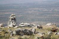 Rebel fighters from the Ahrar al-Sham Islamic Movement walk on a hill in Jabal al-Arbaeen, which overlooks the northern town of Ariha, one of the last government strongholds in the Idlib province May 26, 2015. REUTERS/Khalil Ashawi