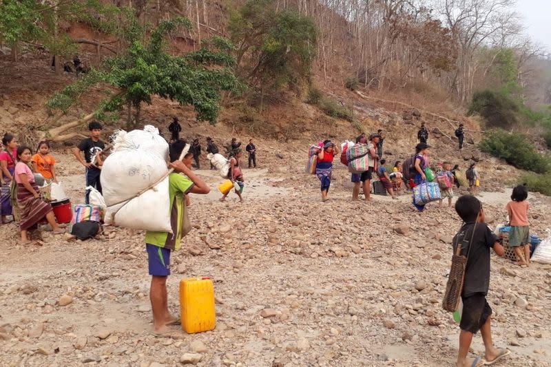 Karen refugees carrying belongings are seen at Salween riverbank in Mae Hong Son