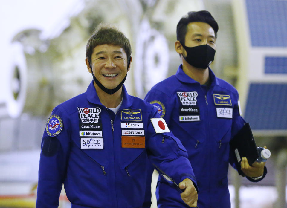 Space flight participants Yusaku Maezawa, left, and Yozo Hirano attend a training ahead of the expedition to the International Space Station at the Gagarin Cosmonauts' Training Center in Star City outside Moscow, Russia, Thursday, Oct. 14, 2021. A Japanese fashion tycoon who's booked a SpaceX ride to the moon is going to try out the International Space Station first. Yusaku Maezawa announced that he's bought two seats on a Russian Soyuz capsule. He'll blast off in December on the 12-day mission with his production assistant and a professional cosmonaut. (Shamil Zhumatov/Pool Photo via AP)