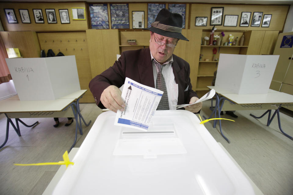 Bosnian man cast his vote at poling station in Sarajevo, Bosnia, on Sunday, Oct. 7, 2018. Polls have opened in Bosnia for a general election that could install a pro-Russian nationalist to a top post and cement ethnic divisions drawn in a brutal war more than 20 years ago. Sunday's vote is seen as a test of whether Bosnia will move toward integration in the European Union and NATO or remain entrenched in war-era rivalries.(AP Photo/Amel Emric)