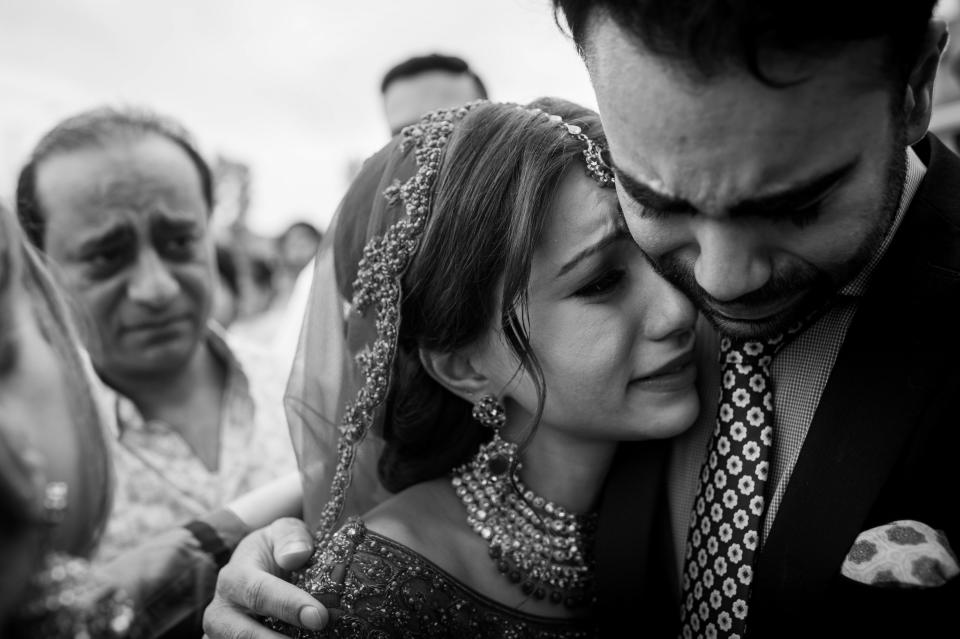 "Vinita hugging her brother (with her father in the background) after her wedding ceremony. It's a traditional part of the Sikh ceremony where the bride's&nbsp;family does a farewell called the 'doli'." --&nbsp;<i>Gurminder Banga</i>