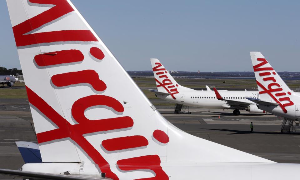 <span>Virgin Australia sacked cabin crew member Dylan Macnish after accessing hotel CCTV footage and room swipecard records which revealed he had organised a Grindr hookup.</span><span>Photograph: Rick Rycroft/AP</span>