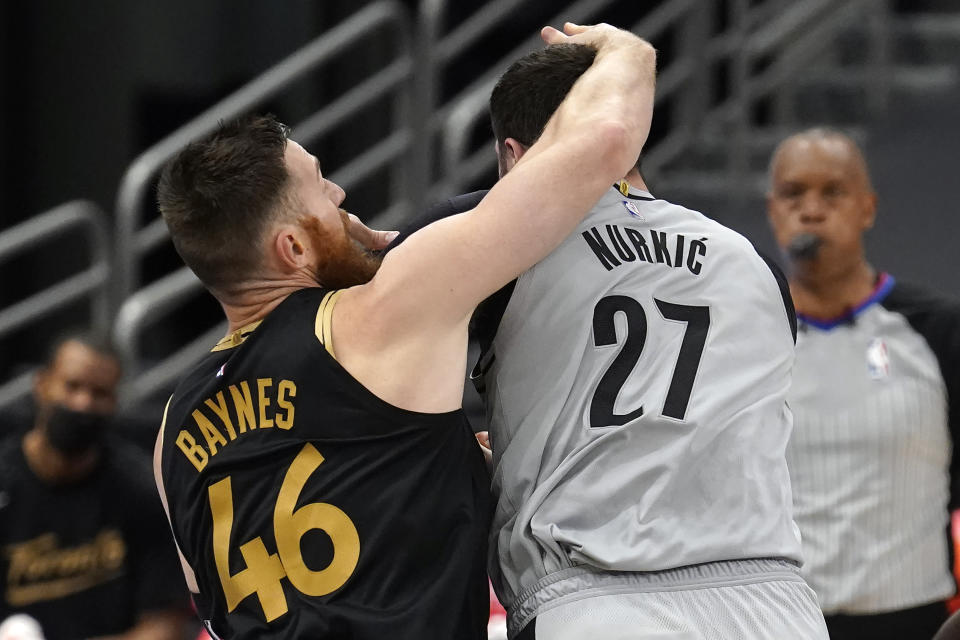 Toronto Raptors center Aron Baynes (46) fouls Portland Trail Blazers center Jusuf Nurkic (27) during the second half of an NBA basketball game Sunday, March 28, 2021, in Tampa, Fla. After a review, Baynes was called for a flagrant foul. (AP Photo/Chris O'Meara)