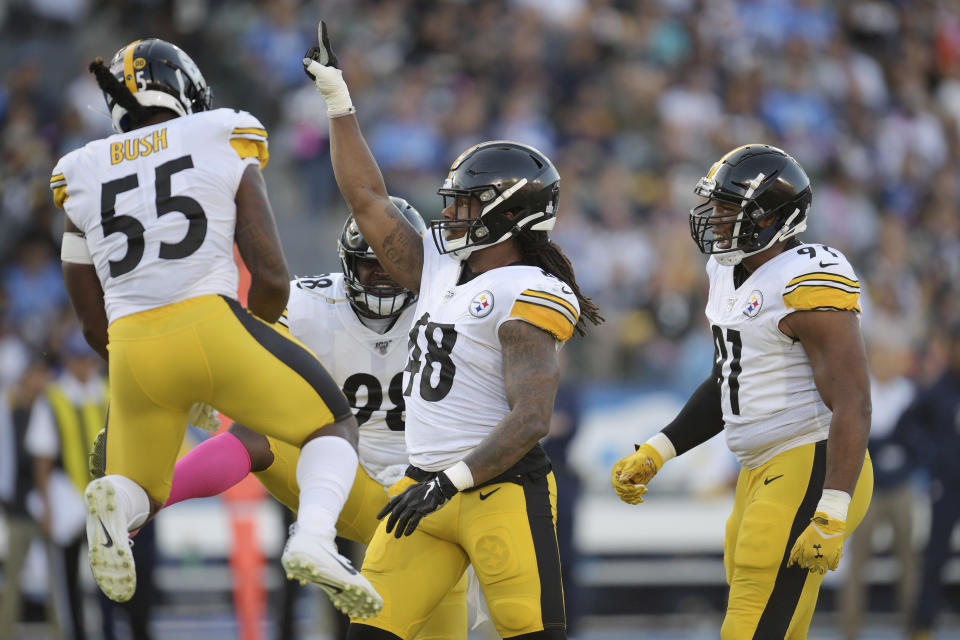 Pittsburgh Steelers outside linebacker Bud Dupree, second from right, celebrates a tackle with linebacker Devin Bush, left, inside linebacker Vince Williams, second from right, and defensive end Cameron Heyward during the first half of an NFL football game against the Los Angeles Chargers, Sunday, Oct. 13, 2019, in Carson, Calif. (AP Photo/Kyusung Gong)